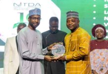 17 NITDA Staff Get Long Service Awards Mall. Kashifu Inuwa (left) presenting a plaque to one of the awardees