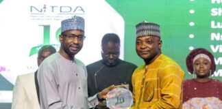 17 NITDA Staff Get Long Service Awards Mall. Kashifu Inuwa (left) presenting a plaque to one of the awardees