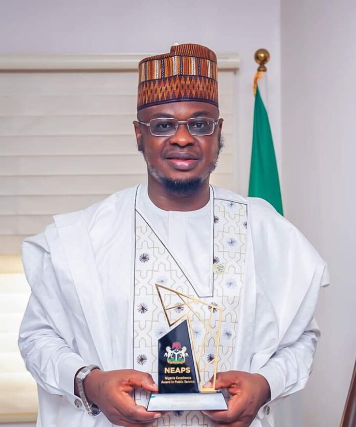 Pantami holding the award plaque he received from President Buhari