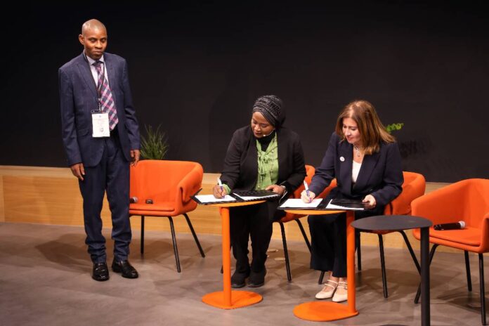 Ag. Director Digital Literacy &Capacity Development Department, Dr Amina Sambo and the Vice President of CISCO Middle East & Africa, Reem Asaad singing the MoU