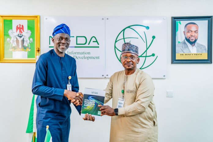 DG rep., Director ITIS, Mr Oladejo Olawumi (left) presenting the agency's SRAP to the Ag. Chairman, FCT-UBEB, Dr Alhassan Sule (right)